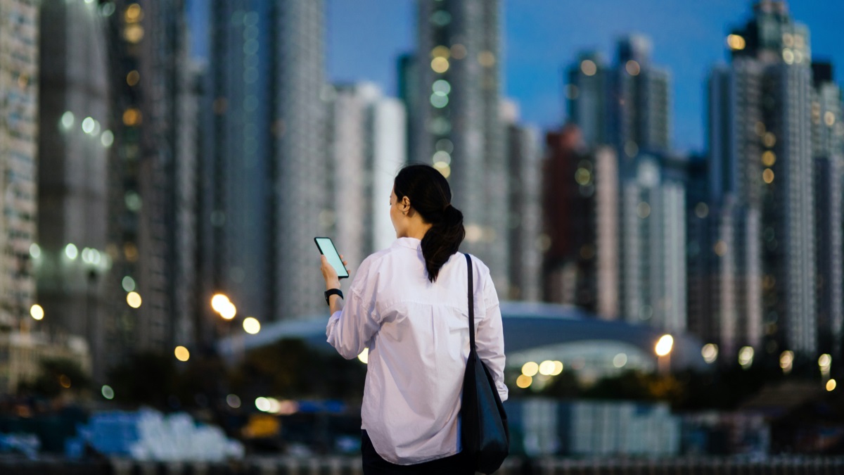 Lady looking at cell phone in urban environment Lady looking at cell phone in urban environment